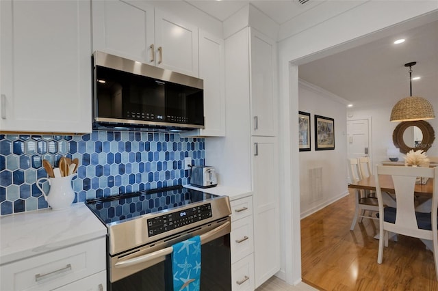 kitchen featuring light hardwood / wood-style floors, white cabinetry, and appliances with stainless steel finishes