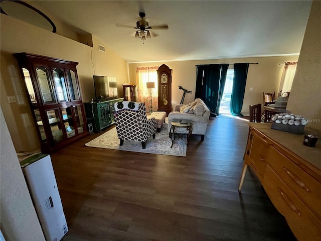 living room with dark hardwood / wood-style floors, vaulted ceiling, and ceiling fan