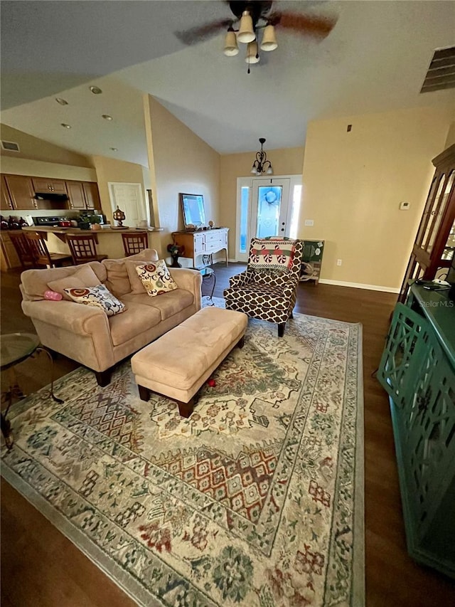 living room with ceiling fan, dark wood-type flooring, and vaulted ceiling