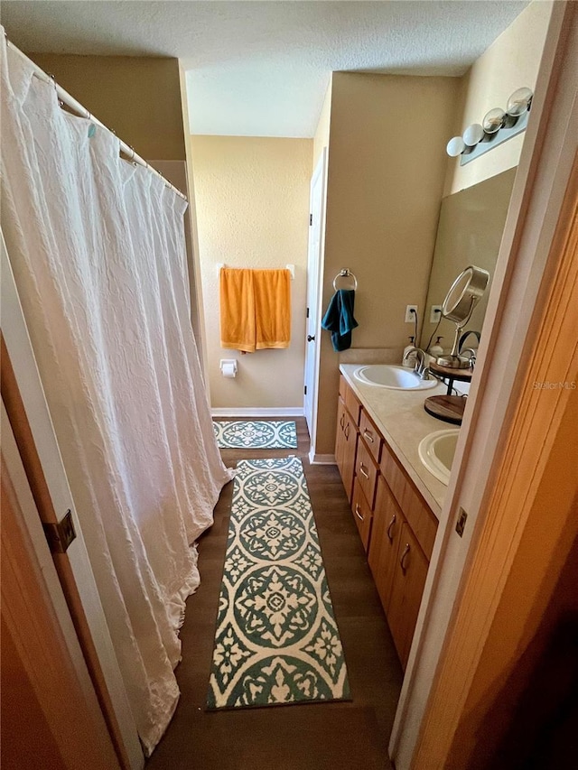 bathroom with vanity and wood-type flooring