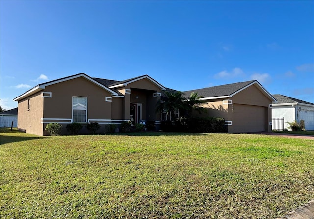 ranch-style house with a garage and a front yard