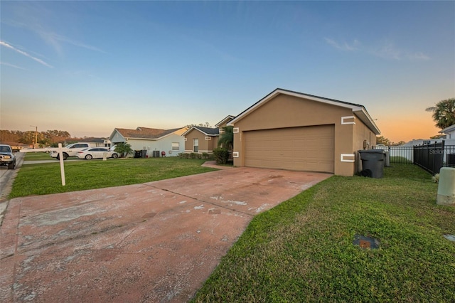 view of front of home with a yard, a residential view, fence, and stucco siding