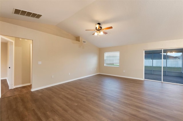 unfurnished room featuring dark wood-style floors, lofted ceiling, visible vents, ceiling fan, and baseboards