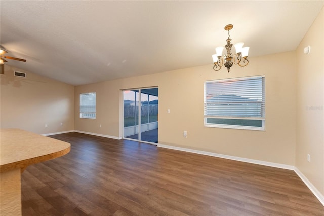 interior space featuring lofted ceiling, dark wood-style flooring, visible vents, and baseboards