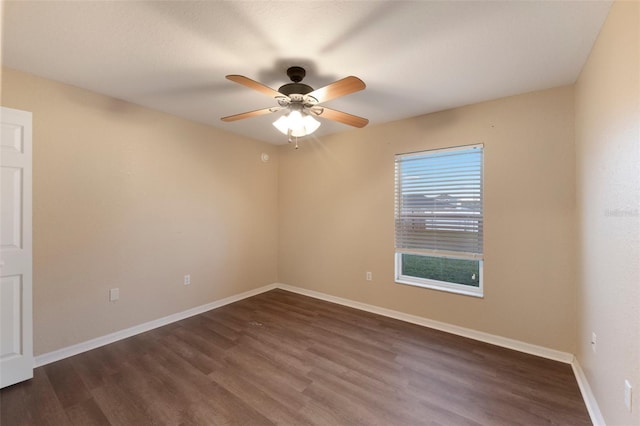 unfurnished room featuring dark wood-style floors, baseboards, and a ceiling fan