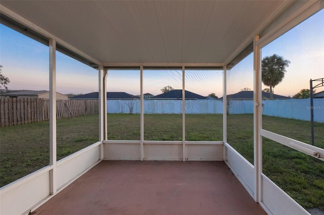 unfurnished sunroom with a water view