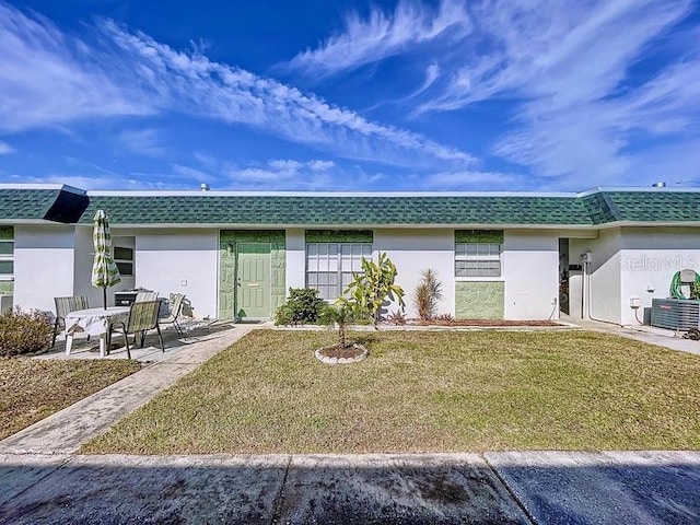 back of house featuring a lawn and a patio area