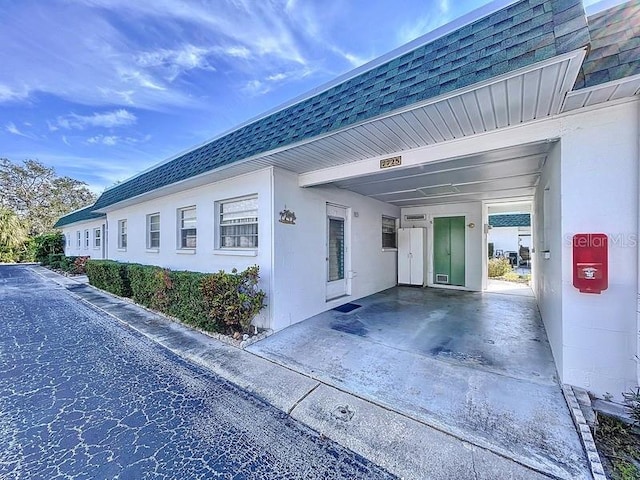 view of side of property with a carport