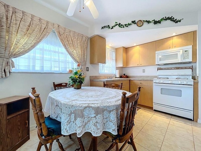 dining area with sink, ceiling fan, and light tile patterned flooring