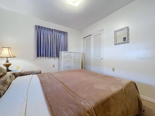 bedroom featuring a closet, carpet, and a textured ceiling