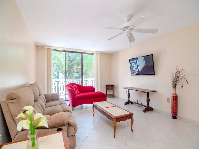 living room featuring ceiling fan, a wall of windows, and a textured ceiling