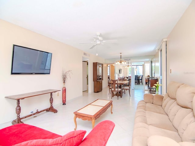 living room featuring ceiling fan with notable chandelier