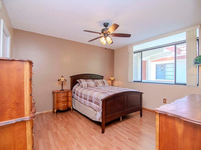 bedroom with ceiling fan and light wood-type flooring