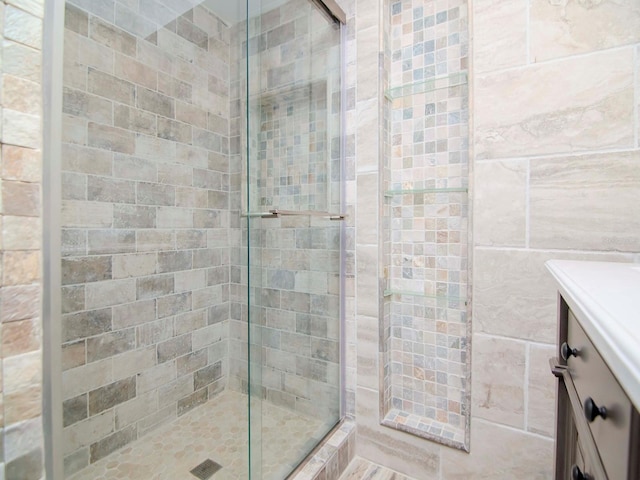 bathroom featuring an enclosed shower and tile walls