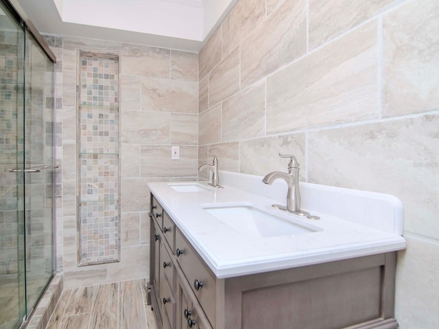 bathroom featuring vanity, tile walls, and a shower with shower door