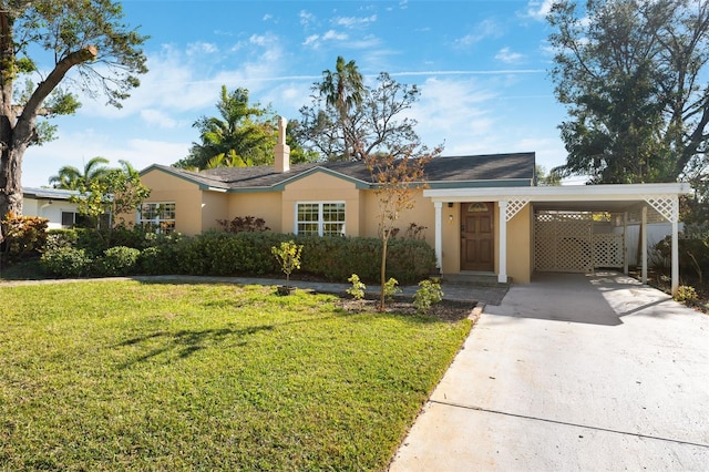 single story home with a front lawn and a carport