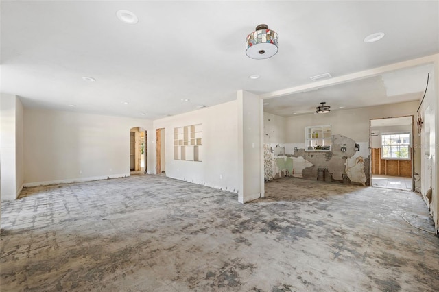 unfurnished living room featuring ceiling fan