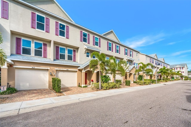 townhome / multi-family property featuring a garage