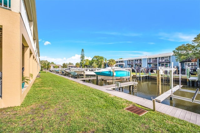 view of dock featuring a yard and a water view