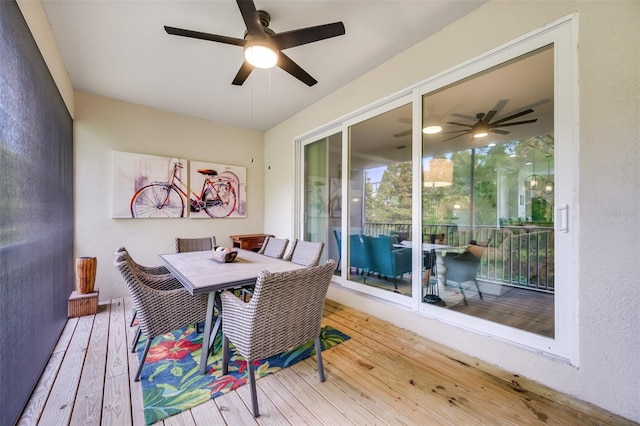 sunroom / solarium featuring ceiling fan