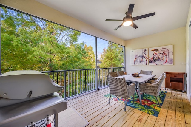 sunroom / solarium featuring ceiling fan