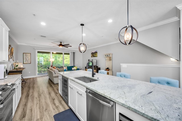 kitchen with white cabinetry, sink, light hardwood / wood-style floors, and appliances with stainless steel finishes