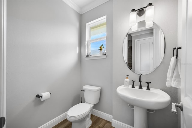 bathroom with toilet, wood-type flooring, and ornamental molding