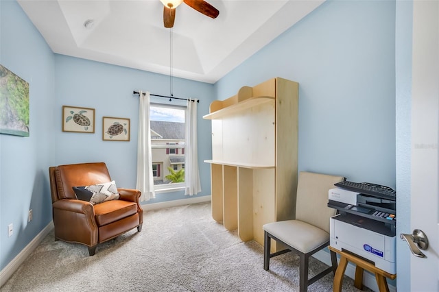 sitting room with a tray ceiling, ceiling fan, and light colored carpet