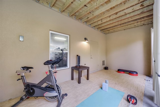 exercise room with hardwood / wood-style floors