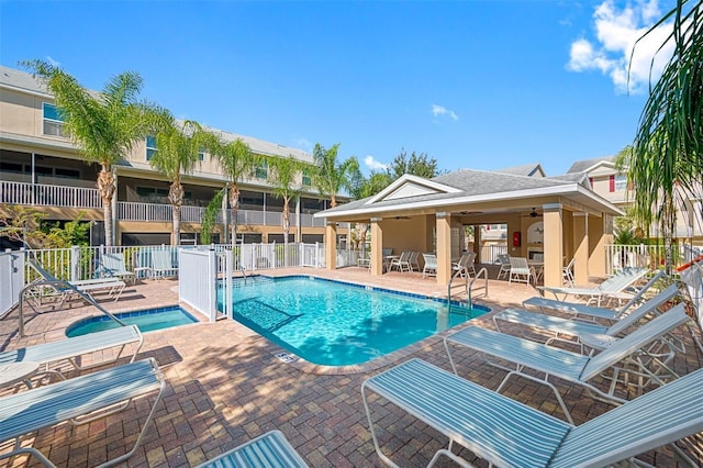 view of swimming pool with ceiling fan and a patio area