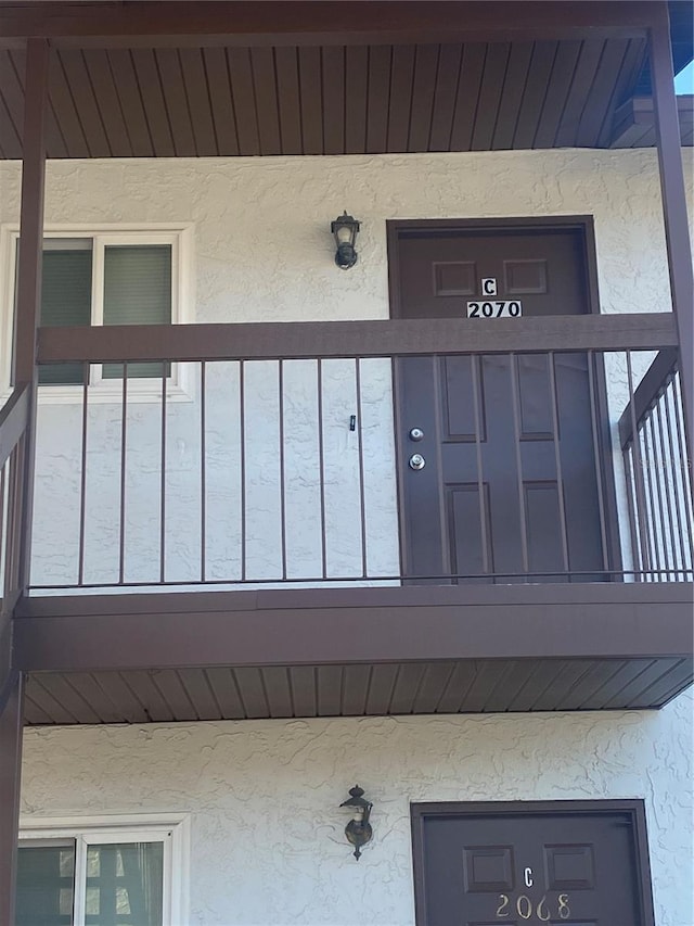 entrance to property with a balcony