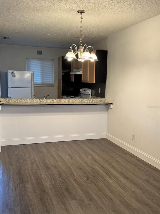 kitchen with a textured ceiling, white appliances, and dark wood-type flooring