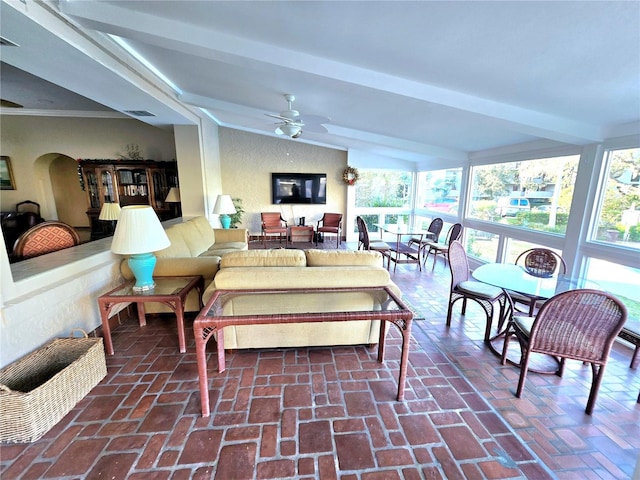 living room featuring vaulted ceiling with beams and ceiling fan