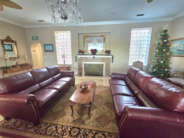 living room with a premium fireplace and ornamental molding