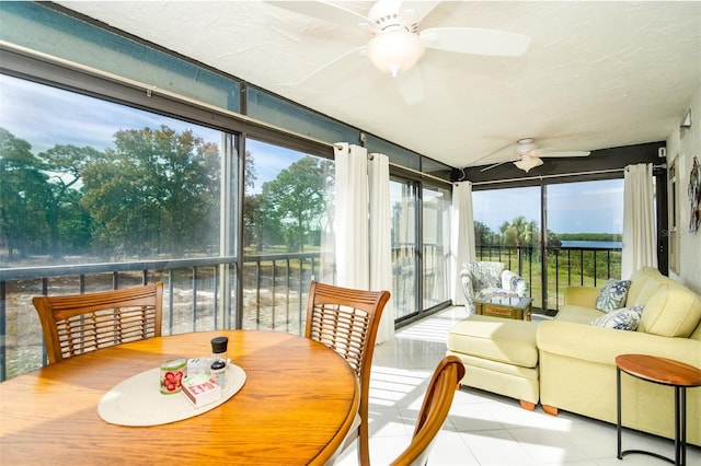 sunroom / solarium with a wealth of natural light and ceiling fan