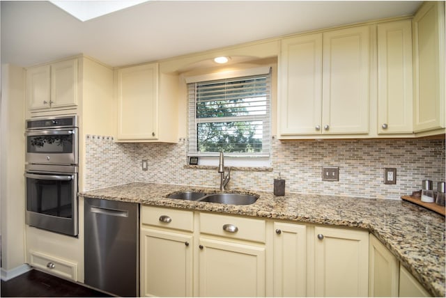 kitchen featuring cream cabinetry, appliances with stainless steel finishes, and sink