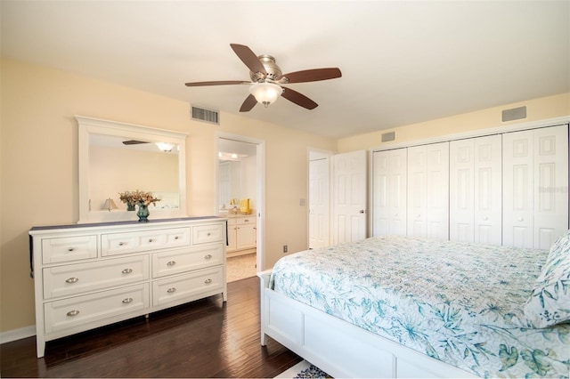 bedroom with ceiling fan, ensuite bathroom, and dark wood-type flooring