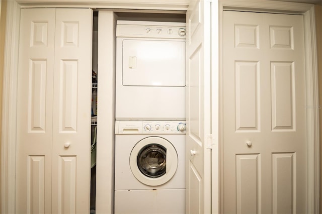 clothes washing area with stacked washer / drying machine