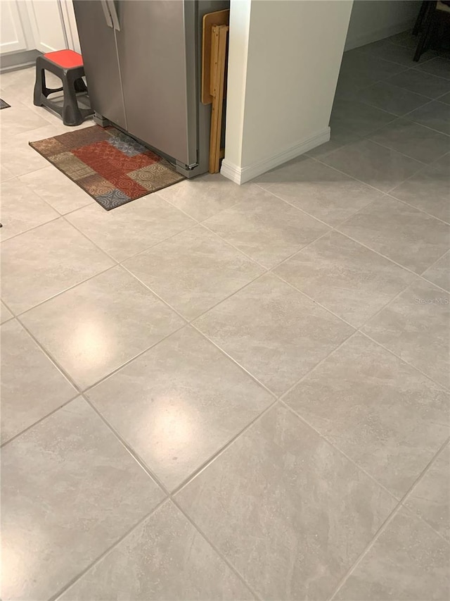 room details featuring white cabinets and stainless steel fridge