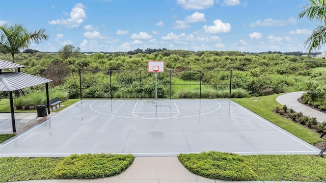 view of basketball court with community basketball court and a view of trees