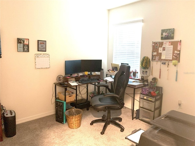 carpeted office space featuring baseboards