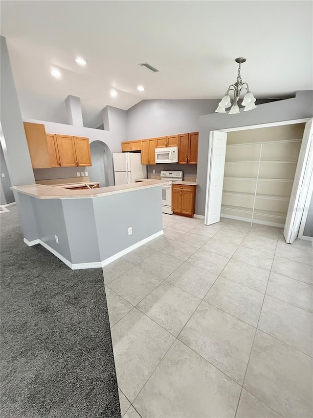 kitchen featuring an inviting chandelier, vaulted ceiling, decorative light fixtures, white appliances, and light tile patterned floors