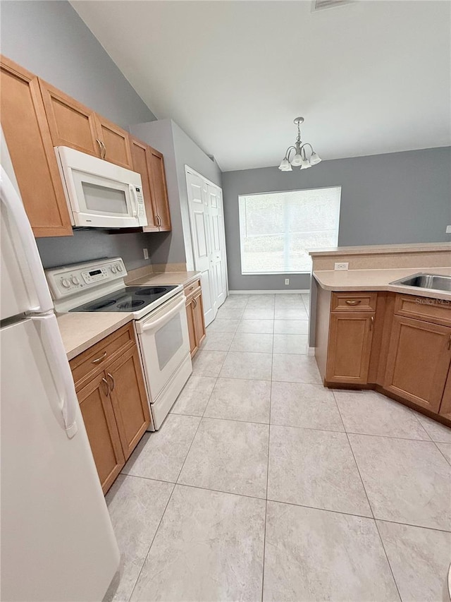 kitchen with white appliances, sink, decorative light fixtures, light tile patterned floors, and a notable chandelier