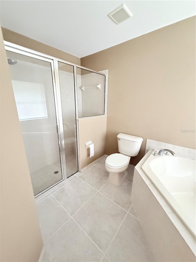 bathroom with tile patterned flooring, toilet, and independent shower and bath