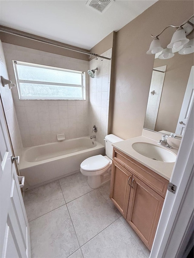 full bathroom featuring tile patterned floors, vanity, tiled shower / bath combo, and toilet