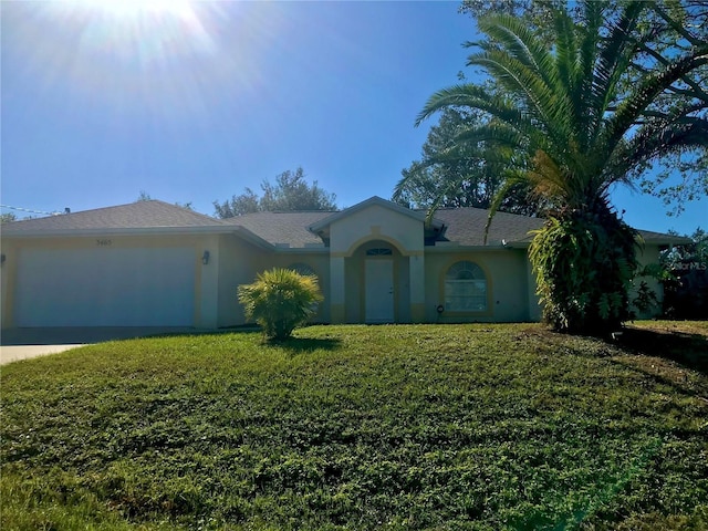 ranch-style home with a garage and a front yard