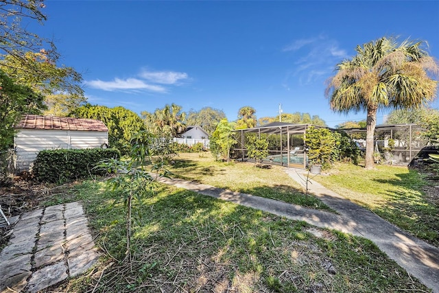 view of yard with a lanai and a fenced in pool