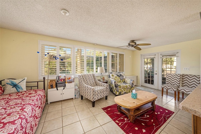 tiled living room with french doors, a textured ceiling, and ceiling fan