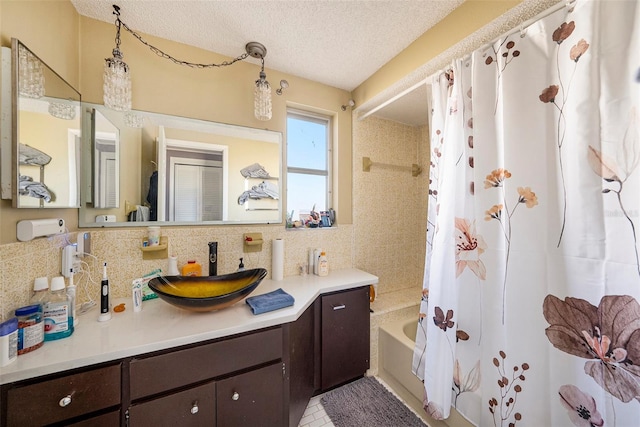 bathroom featuring vanity, shower / bath combo, a textured ceiling, and tile patterned flooring