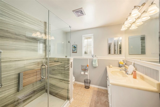 bathroom with tile patterned floors, vanity, toilet, and an enclosed shower